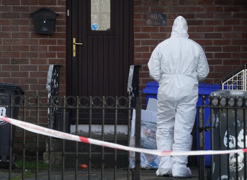 A police forensic officer at the scene in the Greenan area of west Belfast where Kevin Conway was shot dead