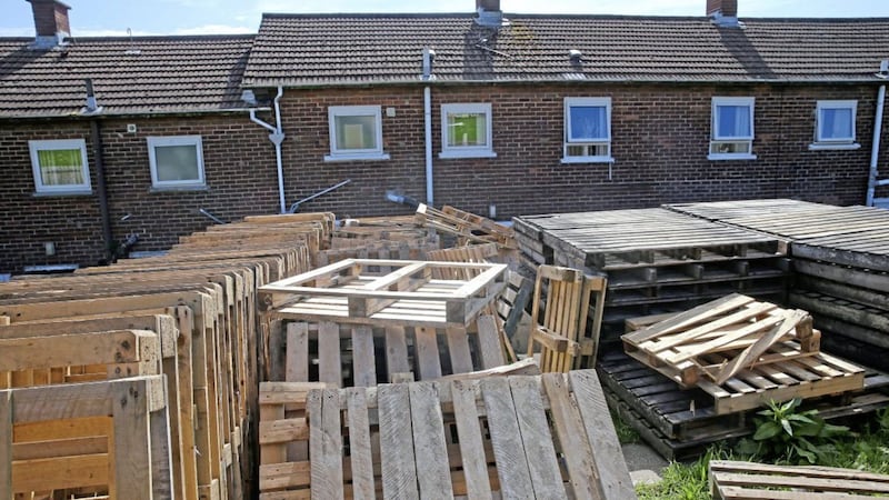 Wooden pallets stacked in the back gardens of homes in the Highfield estate in Belfast 