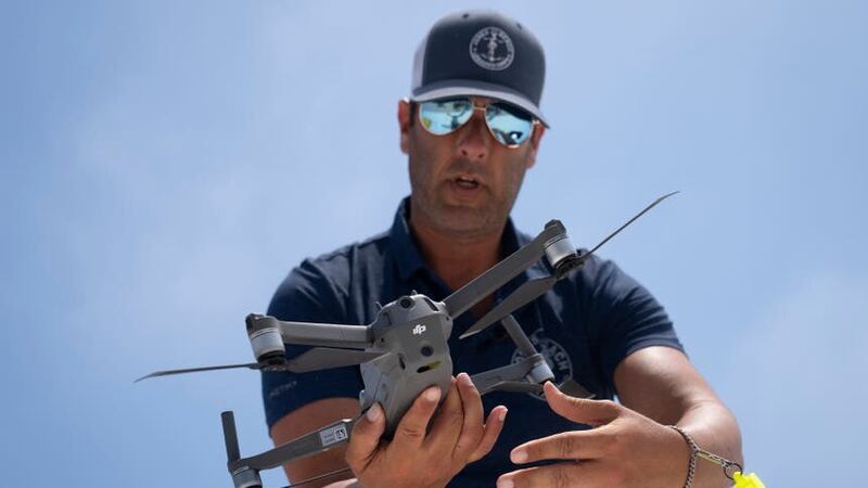 Cary Epstein, a lifeguard supervisor, prepares a drone for a shark patrol flight (John Minchillo/AP)