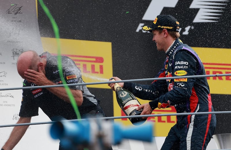 Sebastian Vettel, right, douses Red Bull chief technical officer Adrian Newey with champagne after the 2013 Italian Grand Prix