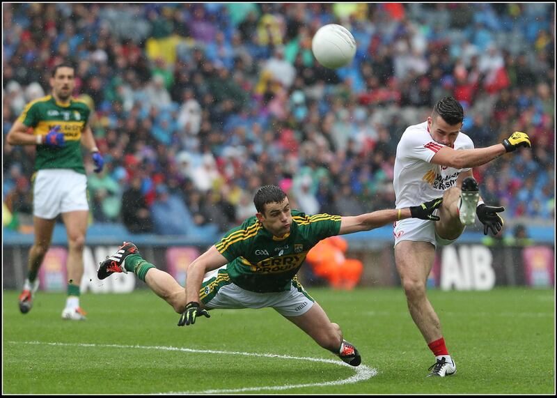 Tyrone's Darren McCurry puts the ball past Kerry's Shane Enright at the All-Ireland GAA football senior championship semi-final in Croke Park, Dublin. Picture by Hugh Russell