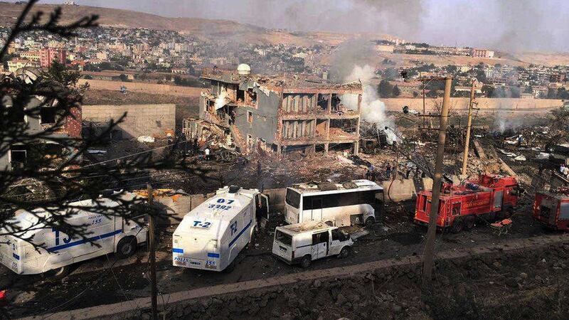 Smoke still rises from the scene after Kurdish militants attacked a police checkpoint in Cizre, southeast Turkey with an explosives-laden truck, killing several police officers and wounding dozens more PICTURE: DHA via AP 