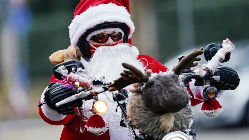 <span style="font-family: Calibri, sans-serif; ">The Advent 'eye of compassion' has inspired a group of bikers in Germany; pictured is Patrick Kuntz, founder of the 'Harley Davidson-riding Santas', riding through Landau city centre dressed as Santa Claus. Since 2015, the bikers have been riding every year on St Nicholas Day to collect donations for a children's hospice. This year, because of the coronavirus pandemic, they rode individually and by distance and not as a column. Picture by Uwe Anspach/dpa via AP</span>