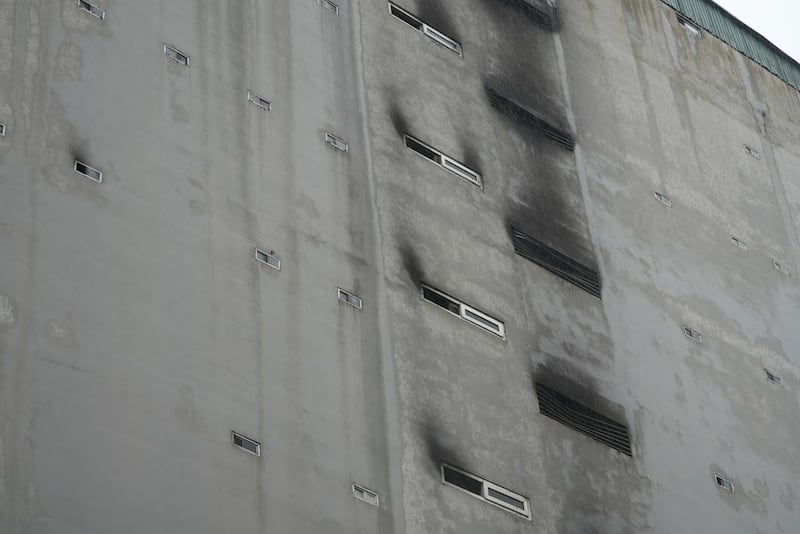 Windows are seen blackened by fire and smoke after a building caught fire in Hanoi