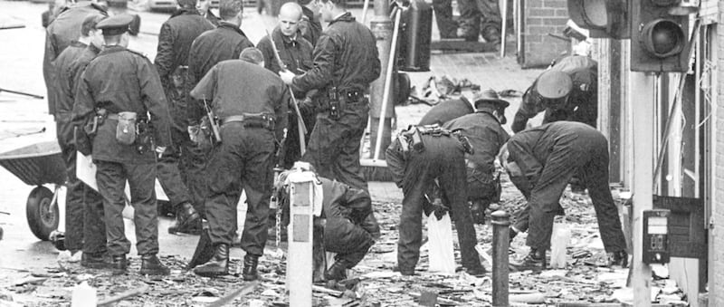 RUC and forensic officers sift through the debris of the Omagh explosion. 