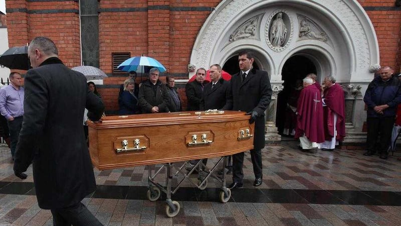 The coffin of &Eacute;amonn &Oacute; Faog&aacute;in leaves St Mary's Church in Belfast after his funeral Mass. Picture by Ann McManus