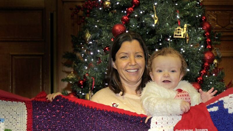 Baby R&iacute;oghnach McGrotty helps launch the Christmas Jumpers World Record attempt with mum Louise James at the Guildhall in Derry. Picture by Margaret McLaughlin 