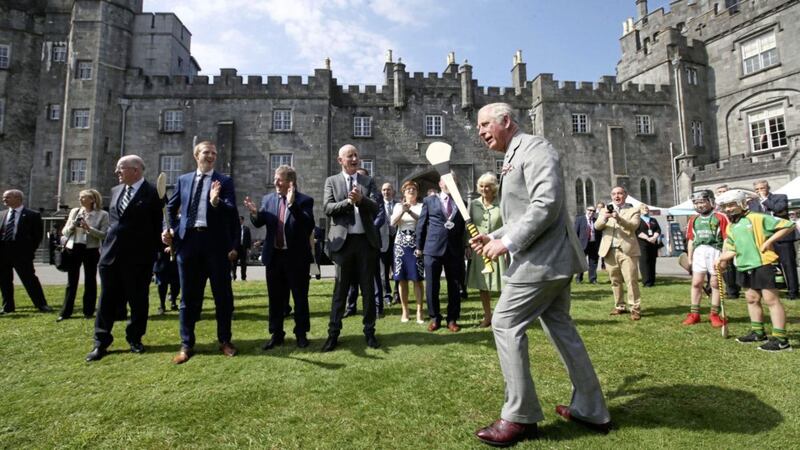 The Prince of Wales tries his hand at hurling as he and the Duchess of Cornwall visit Kilkenny Castle. Picture by Samuel Boal, Press Association 