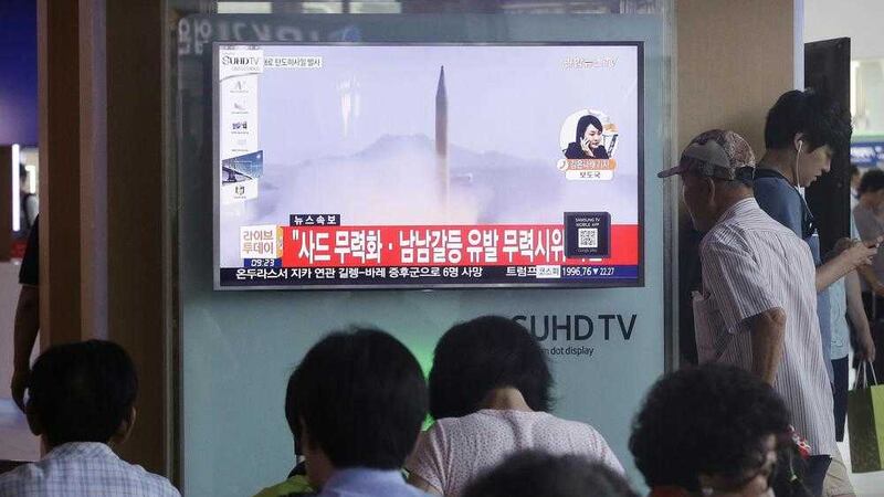 South Koreans watch a TV news program airing file footage of a North Korean rocket launch at the Seoul Railway Station in Seoul, South Korea yesterday PICTURE: Ahn Young-joon/AP 