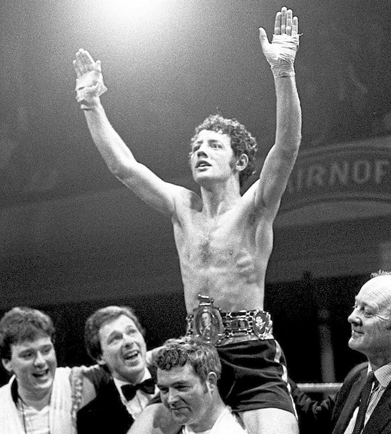 Hugh Russell wins the British bantamweight title at the Ulster Hall in 1983. Barney Eastwood is pictured on the left. 