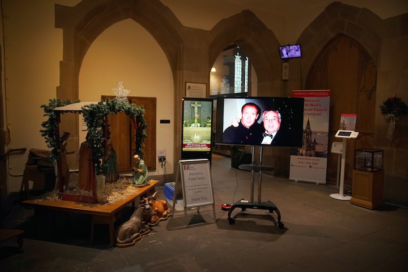 A photo is displayed on a screen ahead of the funeral for former Brookside actor Dean Sullivan