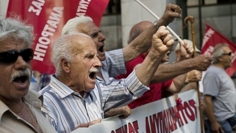 Greek pensioners chant anti-austerity slogans during a protest in central Athens, on Thursday. Greece hope to secure more bailout funds to meet a summer debt repayment hump as well as a debt relief deal at a meeting of finance ministers from the 19-country eurozone PICTURES: Petros Giannakouris/AP 