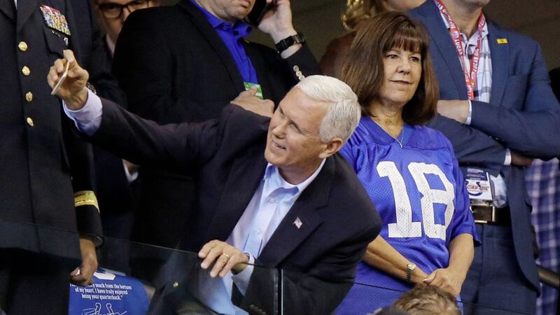 US vice-president Mike Pence takes a photo with a fan before an NFL football game between the Indianapolis Colts and the San Francisco 49ers on Sunday before leaving early PICTURE: AP 