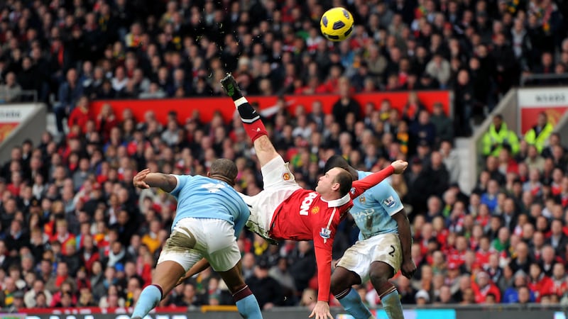 Wayne Rooney (centre) scored a memorable overhead kick against Manchester City in 2011 (Martin Rickett/PA)