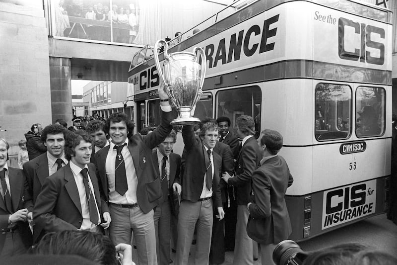 Nottingham Forest’s Larry Lloyd (third left) and Ian Bowyer (third right) held the European Cup aloft as they toured Nottingham in the traditional open-top bus for their civic reception