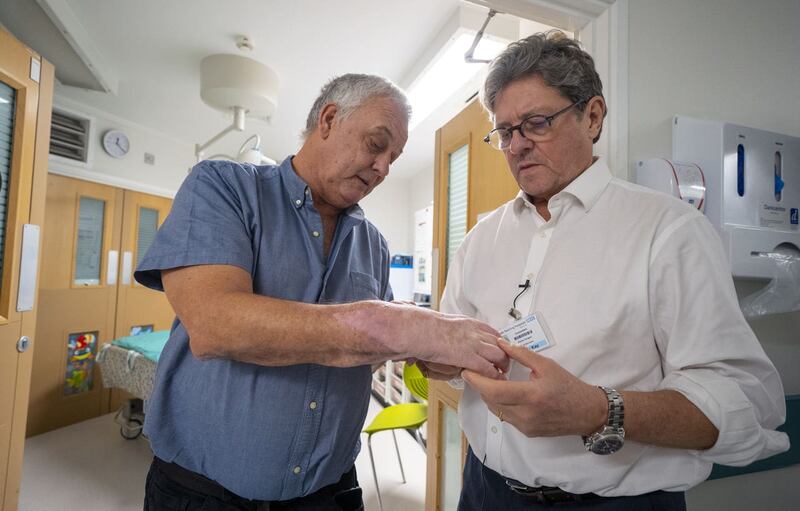 Mark Cahill's hand is examined by surgeon Simon Kay