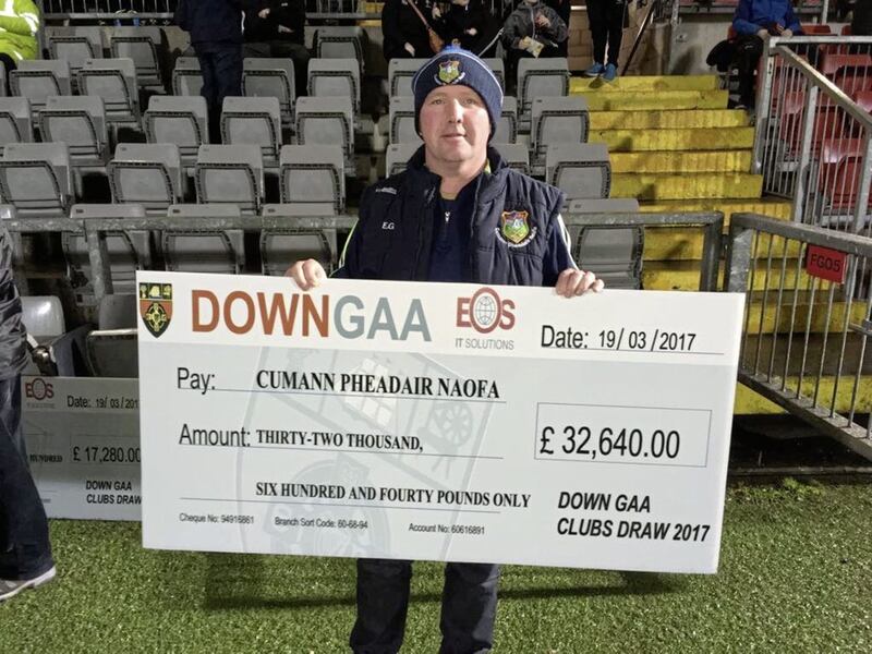 St Peter&rsquo;s, Warrenpoint chairman Eugene Gallagher accepts a cheque for &pound;32,640 following successful sales of county draw tickets 