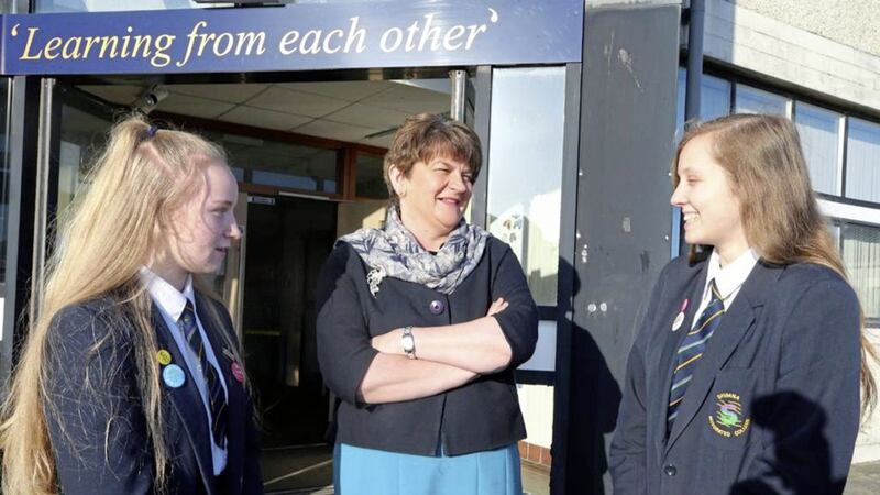 Shimna Integrated College pupils Alice Ballentine and Erin Elliott welcome First Minister Arlene Foster to the school as it celebrates Pasch-Schule status 