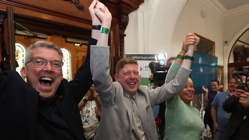 Sinn Fein’s Padraig Donnelly (centre) and Irish Senator Niall ODonnghaile (left) celebrate winning a seat at the Northern Ireland council elections at Belfast City Hall (