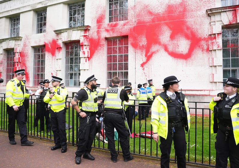 Police officers at the Ministry of Defence after the red paint was thrown  (