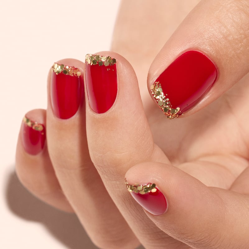 Red nails with glitter tips created by Manucurist