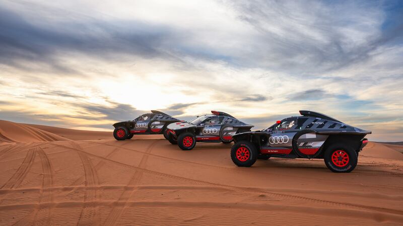 Three Audi RS Q e-trons pictured in the desert ahead of the Dakar Rally 2024