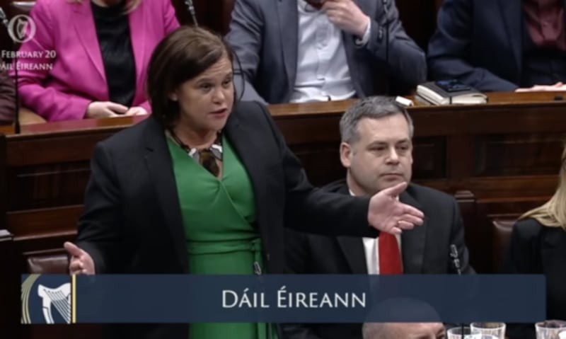 Mary Lou McDonald speaks in the Dail with her arms outstretched