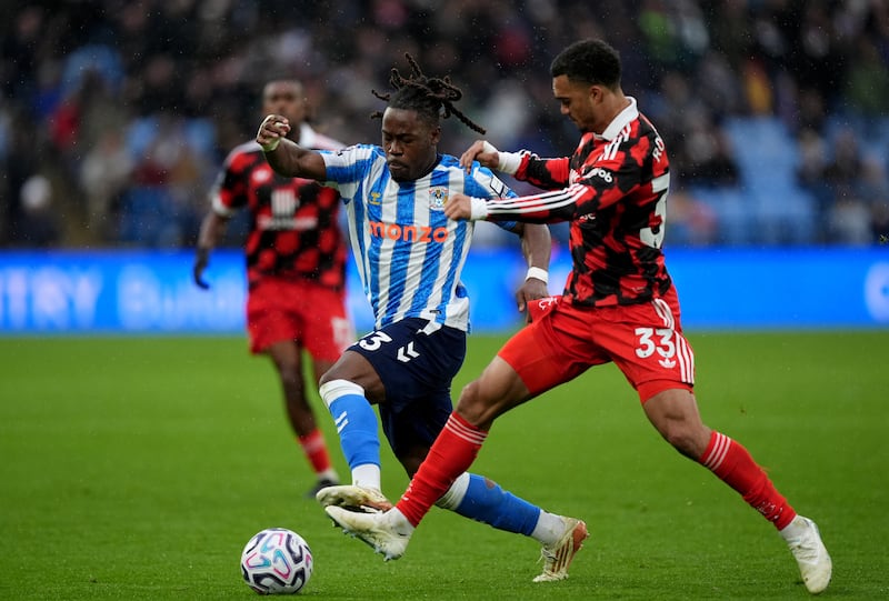 Coventry’s Brandon Thomas-Asante and Fulham’s Antonee Robinson battle for the ball .