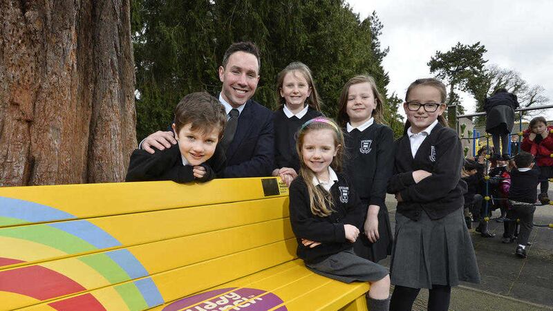 Paddy Wallace with pupils from Whiteabbey PS and their new Buddy Bench 