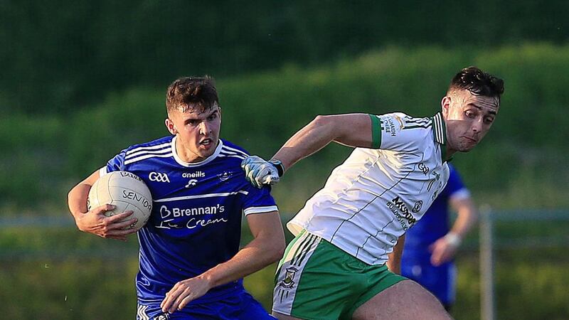 Loughinisland's Declan McClements holds off Ryan Trainor of Burren, but the latter's successful penalty kick separated the sides in the end in last night's Down SFC meeting.<br />Picture Philip Walsh