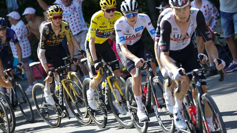 Slovenia's Tadej Pogacar, wearing the best young rider's white jersey, Denmark's Jonas Vingegaard, wearing the overall leader's yellow jersey, and Sepp Kuss of the US, left, climb during the 15th stage of the Tour de France yesterday       PICTURE: AP