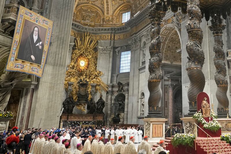 A tapestry with Mama Antula’s image, left, and relics placed at the foot of the main altar in St Peter’s Basilica during her canonisation (Alessandra Tarantino/AP)