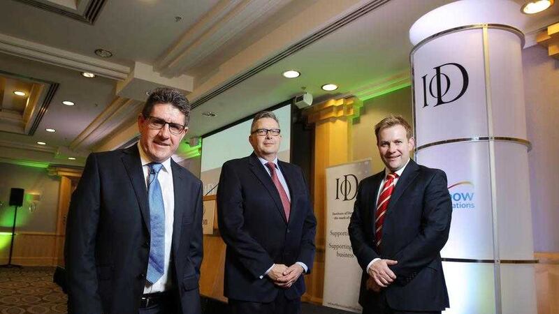 Paul Terrington, chairman of IoD NI, with Stuart Carson of event sponsors Rainbow Communications and guest speaker Paul Kimmage, the Irish journalist and former cyclist who helped expose the Lance Armstrong doping scandal. Picture: Kelvin Boyes/Press Eye. 