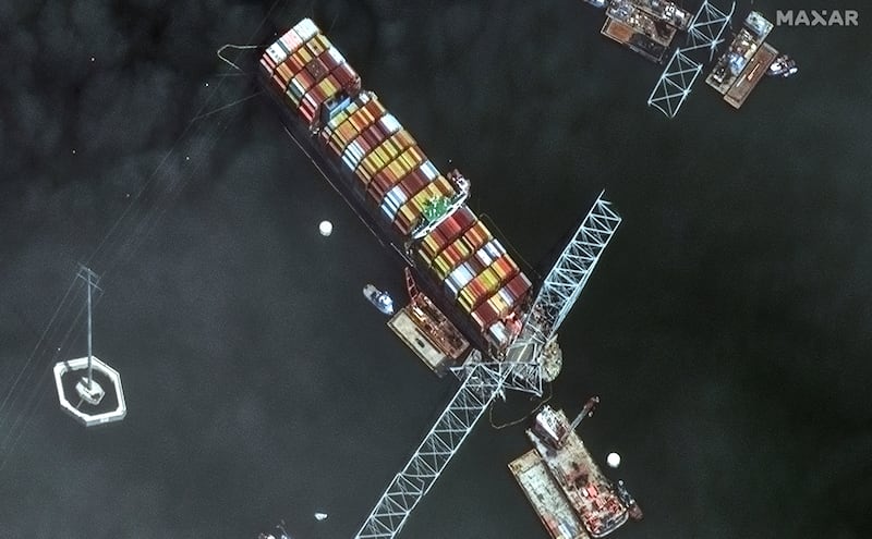 The bow of the container ship Dali remains stuck underneath sections of the fallen Francis Scott Key Bridge (Maxar Technologies via AP)
