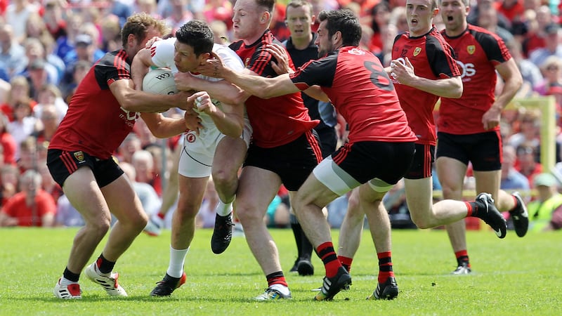 Tyrone&rsquo;s Sean Cavanagh ploughs through the Down rearguard during yesterday&rsquo;s encounter in Clones &nbsp; Picture by Philip Walsh