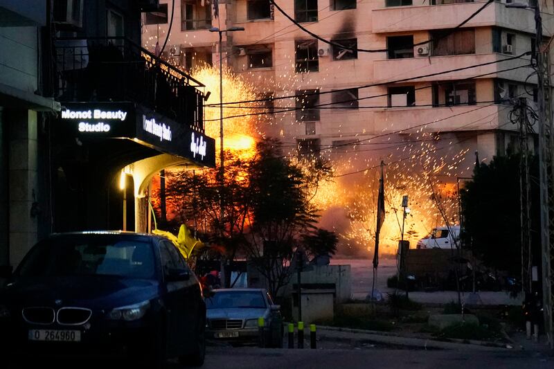Explosions erupt from a building after an Israeli strike in Beirut, Lebanon (Hussein Malla/AP)