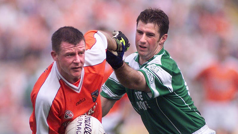 Former Fermanagh captain Raymond Gallagher - pictured in action against Justin McNulty in 2002 - believes the Erne county must improve their underage structures if they are to make further progress 