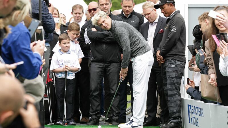 Niall Horan with eight-year-old cancer survivor Rhys Kiernan (left) during the Mega Putt Challenge for Cancer Research UK (Yui Mok/PA)