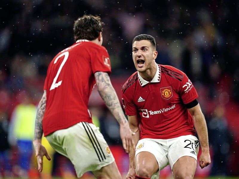               Manchester United&#39;s Victor Lindelof and Diogo Dalot celebrate reaching the FA Cup Final by beating Brighton in a penalty shoot-out on Sunday.        