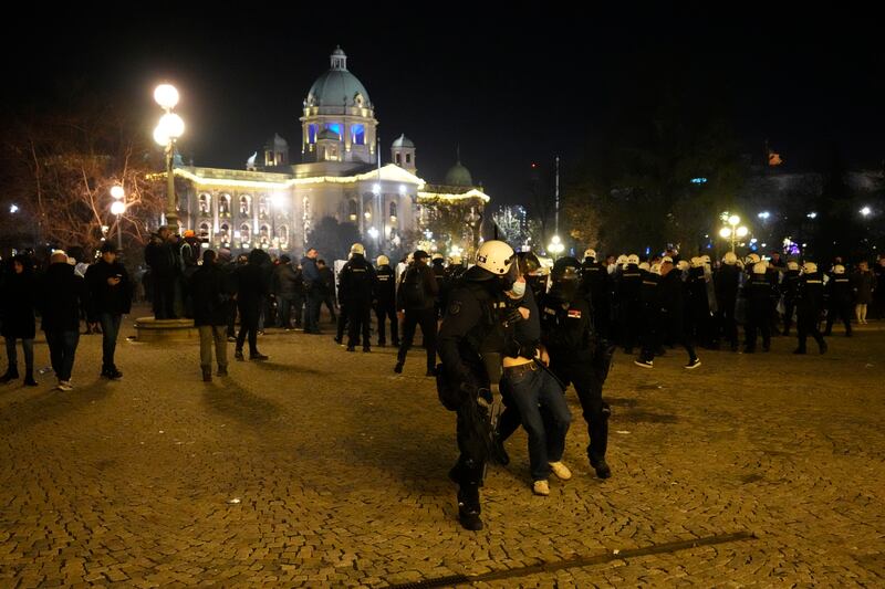 A protester is detained in Belgrade (Darko Vojinovic/AP)