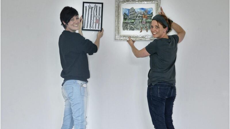 Shauna McCann, right, and Linda Smyth start to hang their exhibition at the Crescent Arts Centre in Belfast Picture: Hugh Russell 