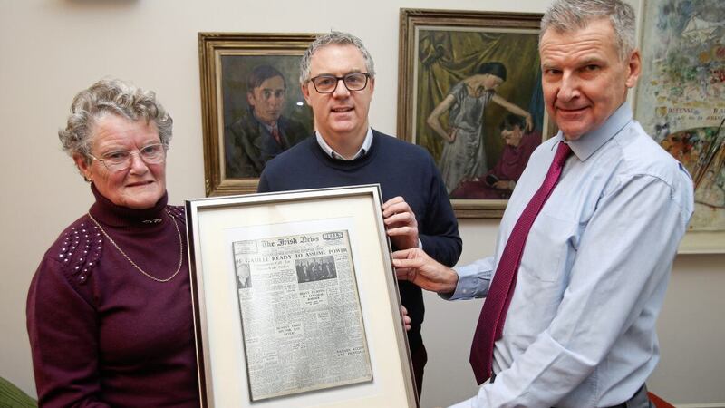 Peggy Pyers, who worked in The Irish News in the 1950s, is presented with a framed front page of the newspaper from her first day working at the publication, by editor Noel Doran and sports editor Paul McConville. Picture by Mal McCann 