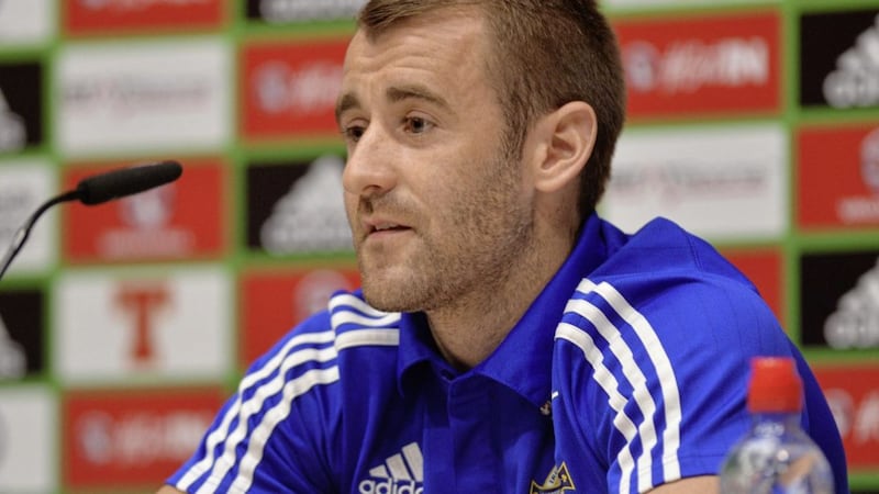 Northern Ireland footballer, Niall McGinn has suggested a helpline be established to help players who are subjected to racist or sectarian abuse 