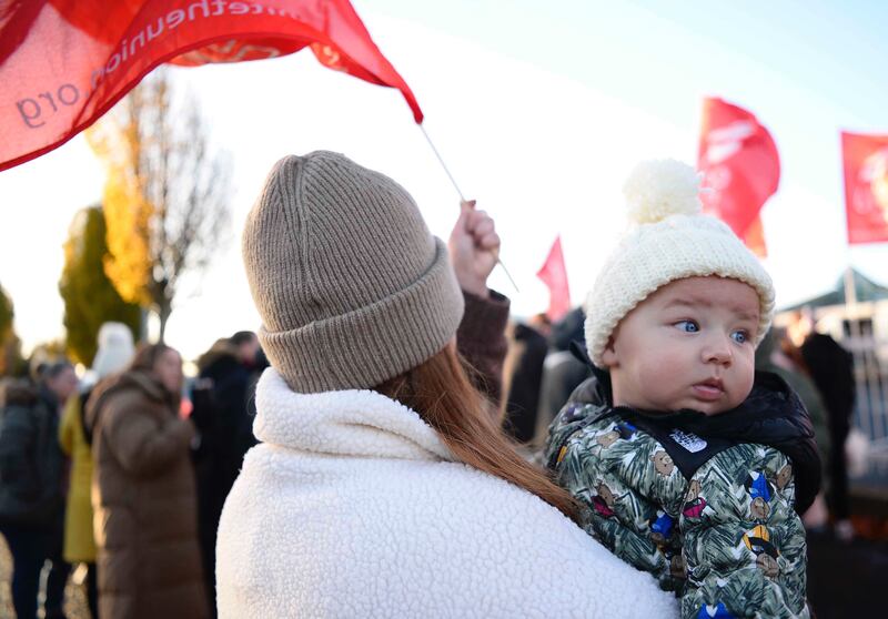 Baby Sonny McCarthy with his childminder at the picket line on Wednesday. Picture by Mark Marlow