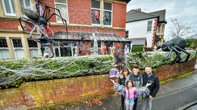The family of four spent the weekend putting up decorations in heavy rain.