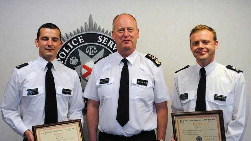 PSNI Chief Constable George Hamilton with Constable Richard Westbury (left) and Sergeant Scott Thompson, both recognised for their bravery in rescuing a Lisburn woman from a house fire. 