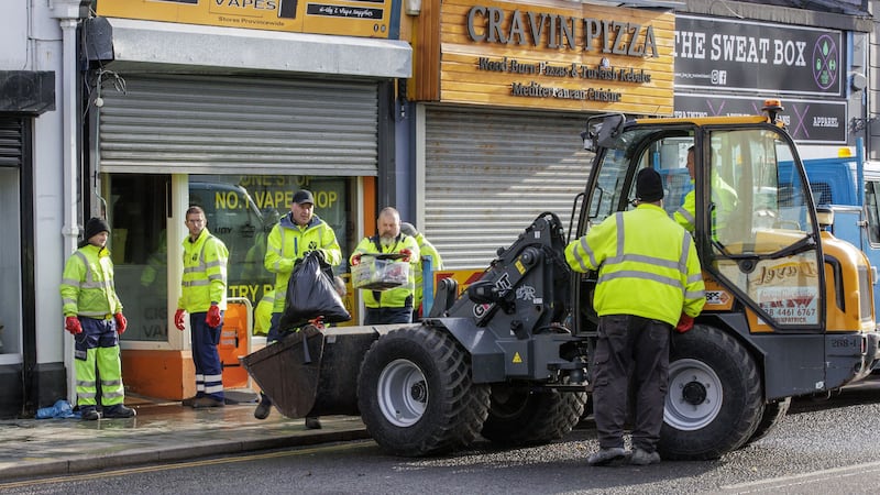 Council workers from Newry, Mourne and Down District Council help clean up flood-stricken Downpatrick, Co Down (Liam McBurney/PA)