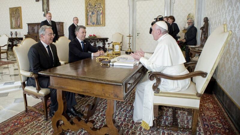 Pope Francis talks to Colombian president Juan Manuel Santos, center, and former president Alvaro Uribe, left, during a meeting at the Vatican Picture by L'Osservatore Romano/Pool photo via AP