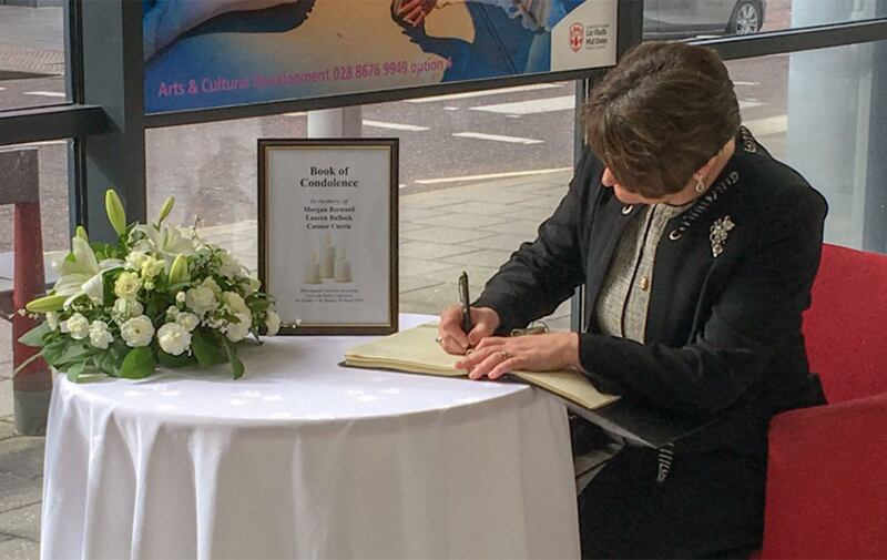 DUP leader Arlene Foster signing a book of condolence for the Cookstown victims. Picture from the BBC, Twitter