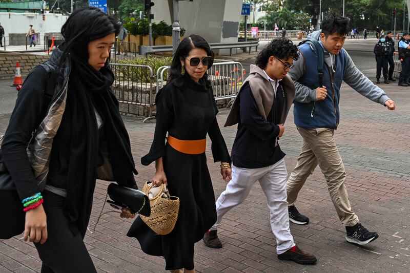 Jimmy Lai’s wife Teresa Lai, second left, and his son Lai Shun Yan, right, arrive at West Kowloon Magistrates’ Courts (Billy HC Kwok/AP)